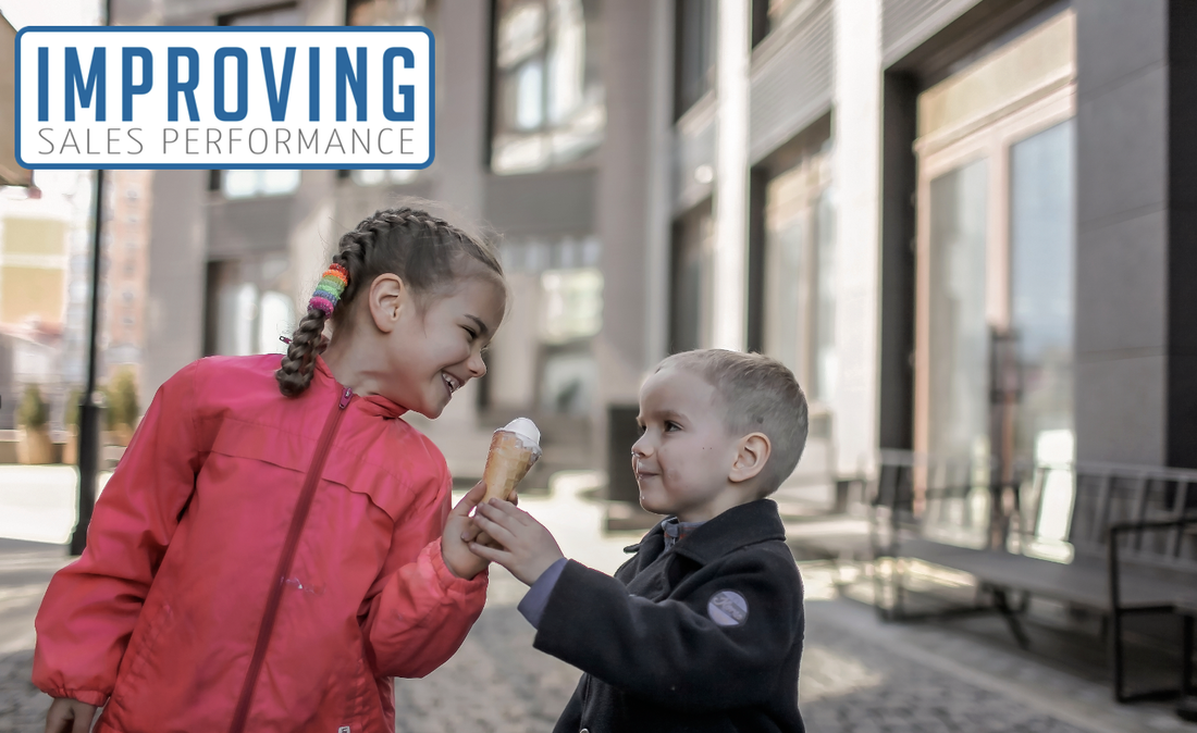 Girls shares ice cream with boy, illustrating the close relationship needed between sales and marketing teams. 