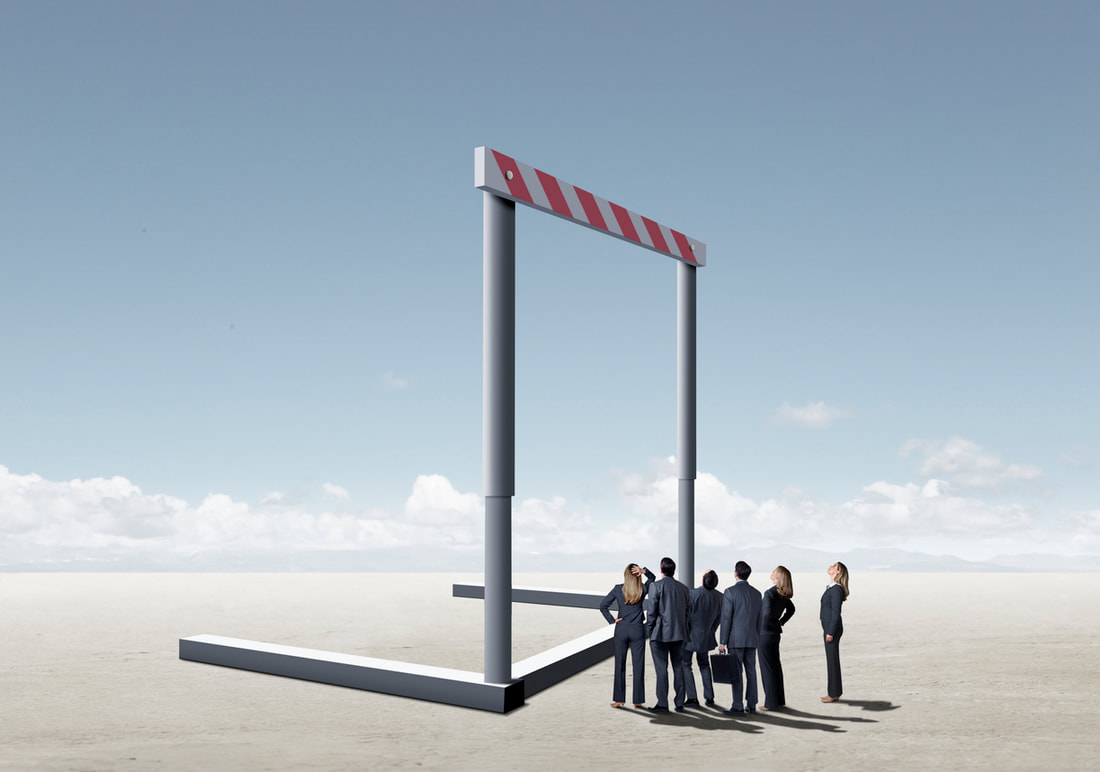 Sales team stands in front of hurdle to discuss success